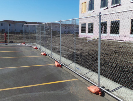 Temporary chain-link fence panels set up along a construction site perimeter